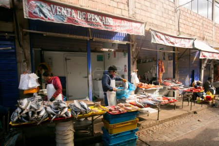 Photo for Cusco, Peru; 1st January 2023: A man selling fish in a street market in Cusco, Peru. - Royalty Free Image