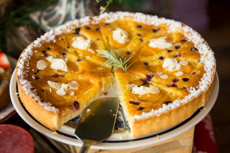 Photo for Peach coconut  pie with blueberries in a pastry shop in the city of Paris in France. - Royalty Free Image