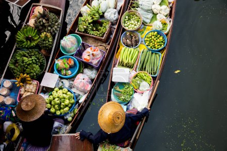 Photo for Amphawa, Thailand; 1st January 2023: Women selling food in their canoes in a floating market in Amphawa district. - Royalty Free Image