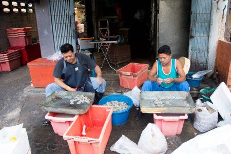 Photo for Bangkok, Thailand; 1st January 2023: People cleaning fish and selling fish in Samut Songkram district. - Royalty Free Image