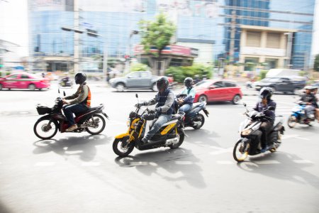 Photo for Bangkok, Thailand; 1st January 2023: Motorbikes driving through the city center of Bangkok. - Royalty Free Image