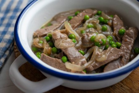 Photo for Beef strips cooked with onion and peas. - Royalty Free Image