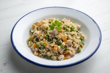 Photo for Traditional Chinese fried rice with 3 delicacies with peas, ham and other vegetables. - Royalty Free Image