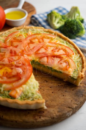 Photo for French style quiche with broccoli, salmon, and slices tomato. - Royalty Free Image