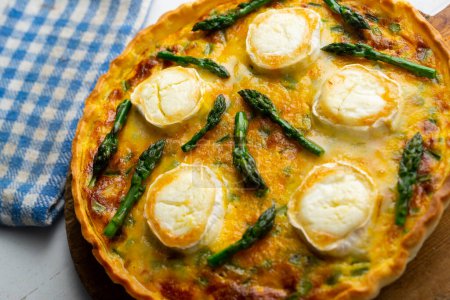 Photo for French style quiche with green asparagus, eggs, and slices of goat cheese. - Royalty Free Image
