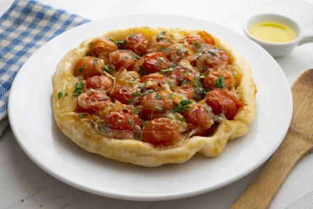 Photo for Savory tarte tatin with cherry tomatoes and onion. - Royalty Free Image