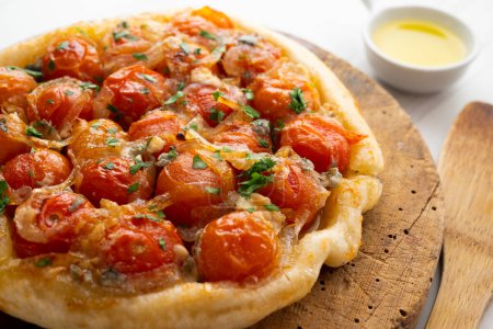 Photo for Savory tarte tatin with cherry tomatoes and onion. - Royalty Free Image