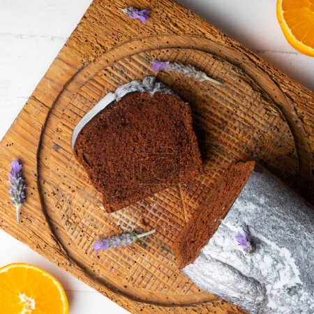 Photo for Chocolate cake with orange and some lavender flowers to decorate. - Royalty Free Image
