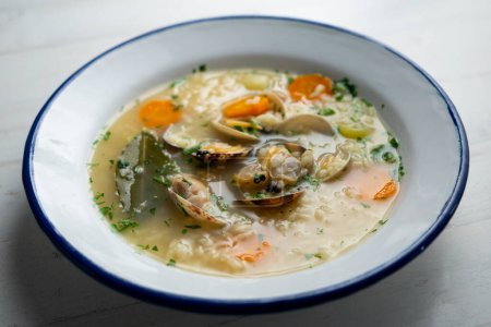 Photo for Noodle soup with clams and carrots and other seasonal vegetables. - Royalty Free Image
