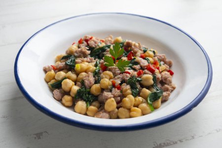 Photo for Chickpea salad with spinach, minced pork and red pepper. - Royalty Free Image