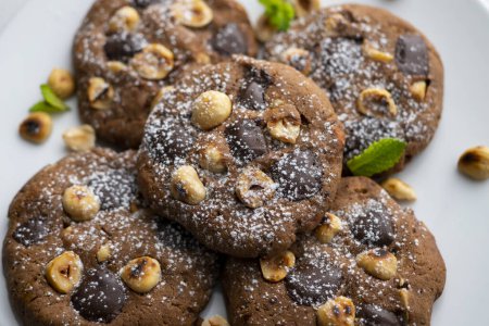 Photo for Homemade chocolate cookies with hazelnut pieces. - Royalty Free Image
