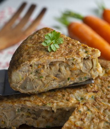 Photo for Spanish omelet made with rice and carrot and artichokes. - Royalty Free Image