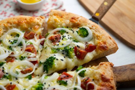 Photo for Neapolitan pizza with cheese, onion, broccoli and cherry tomatoes. - Royalty Free Image