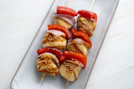 Photo for Chicken skewers with teriyaki sauce skewered with red pepper and onion. - Royalty Free Image