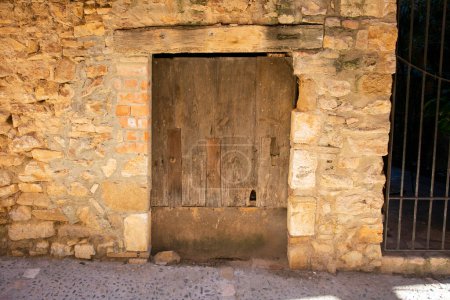 Photo for Old wood door from a medieval town of Alquezar in Huesca in Spain. - Royalty Free Image