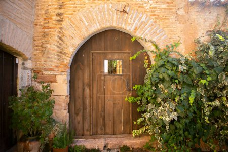 Photo for Old wood door from a medieval town of Alquezar in Huesca in Spain. - Royalty Free Image