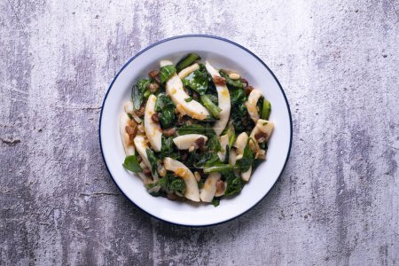 Photo for Cuttlefish cooked with chard and spinach. Spanish traditional tapas. - Royalty Free Image