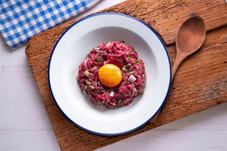 Photo for Traditional steak tartare with beef and egg yolk. - Royalty Free Image