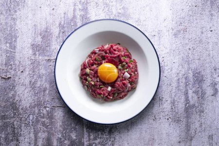 Photo for Traditional steak tartare with beef and egg yolk. - Royalty Free Image
