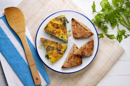 Photo for Spanish potato omelette with spinach. Traditional tapa. - Royalty Free Image