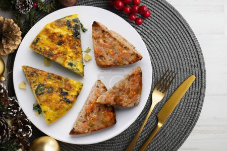 Photo for Spanish potato omelette with spinach. Traditional tapa. Christmas food served on a table decorated with Christmas motifs. - Royalty Free Image