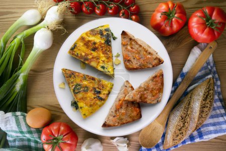 Photo for Spanish potato omelette with spinach. Traditional tapa. - Royalty Free Image