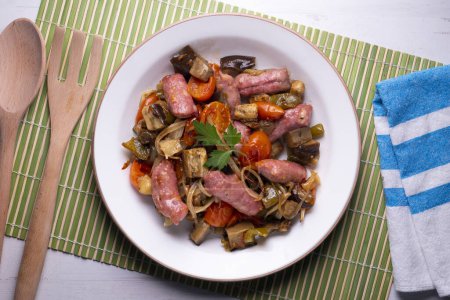 Photo for Iberian pork sausages sauted with vegetables. Spanish tapa. - Royalty Free Image