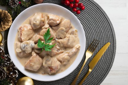 Photo for Meat with strogonoff sauce. Traditional Russian recipe. Christmas food on a table with decorations. - Royalty Free Image