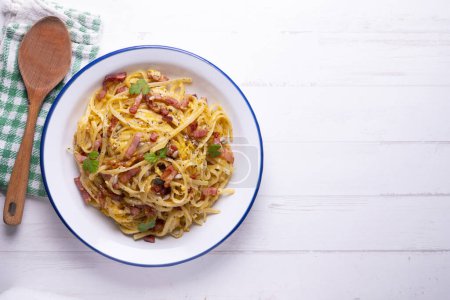 Photo for Carbonara pasta. Carbonara is an Italian pasta dish from Rome made with eggs, hard cheese, cured pork, and black pepper. - Royalty Free Image