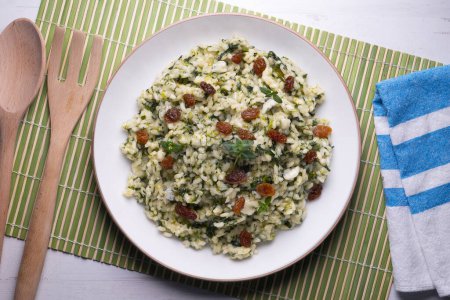 Photo for Rice with spinach and raisins. vegan recipe. - Royalty Free Image