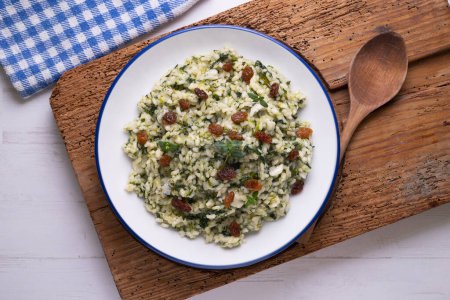 Photo for Rice with spinach and raisins. vegan recipe. - Royalty Free Image