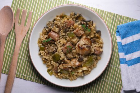 Photo for Rice paella with rabbit, sausages and green beans. Tapa traditional recipe in Valencia, Spain. - Royalty Free Image