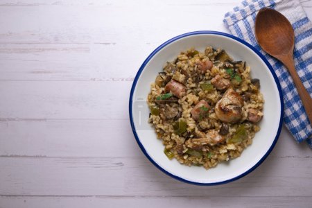 Photo for Rice paella with rabbit, sausages and green beans. Tapa traditional recipe in Valencia, Spain. - Royalty Free Image