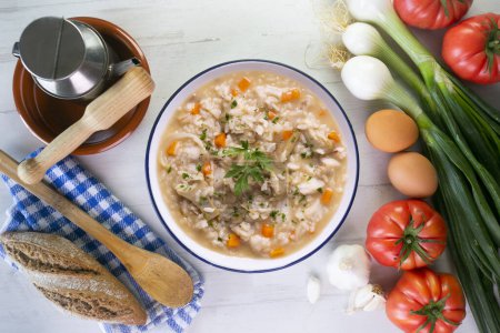 Photo for Soupy rice with artichokes and carrots. Typical Spanish gastronomy dish. - Royalty Free Image