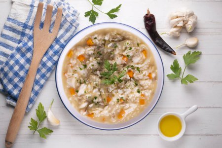 Photo for Soupy rice with artichokes and carrots. Typical Spanish gastronomy dish. - Royalty Free Image