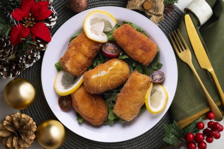 Photo for Fish croquettes. Traditional tapas of the coastal areas in Spain. Christmas food served on a table decorated with Christmas motifs. - Royalty Free Image