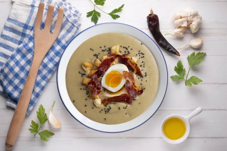 Photo for Smoked aubergine cream with crispy Iberian ham and boiled egg. - Royalty Free Image