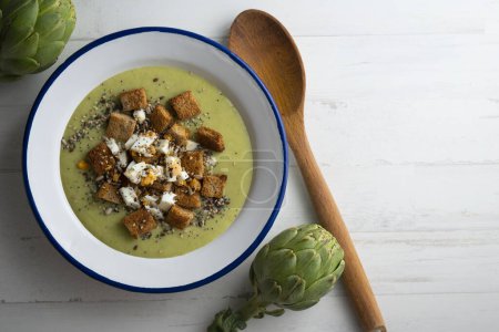 Photo for Artichoke cream with bread croutons. Typical Spanish vegan tapas. - Royalty Free Image