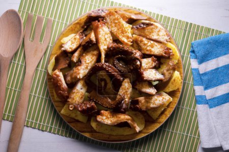 Photo for Pulpo a la Gallega. Octopus cooked with boiled potato, paprika and olive oil. Galician octopus recipe north of Spain tapa. - Royalty Free Image