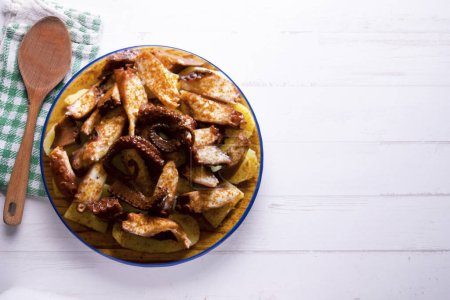Photo for Pulpo a la Gallega. Octopus cooked with boiled potato, paprika and olive oil. Galician octopus recipe north of Spain tapa. - Royalty Free Image