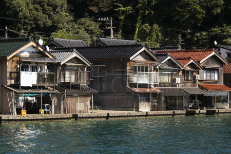 Photo for Beautiful fishing village of Ine in the north of Kyoto. Funaya or boat houses are traditional wooden houses built on the seashore. - Royalty Free Image