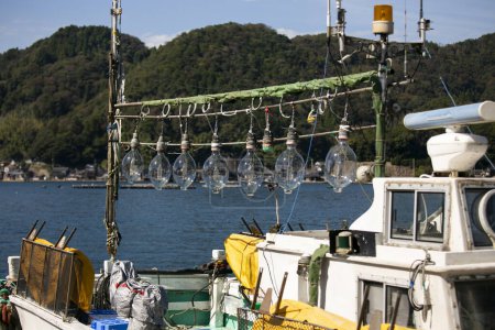 Photo for Lights from a fishing boat prepared to attract octopuses in Ine fishing village in Japan. - Royalty Free Image