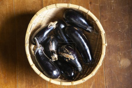 Photo for Japanese eggplants in a wicker basket. - Royalty Free Image