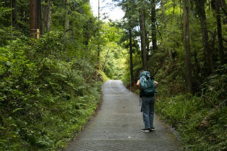 Photo for Walking the road following the Nakasendo trail between Nagiso and Tsumago in Kiso Valley, Japan. - Royalty Free Image