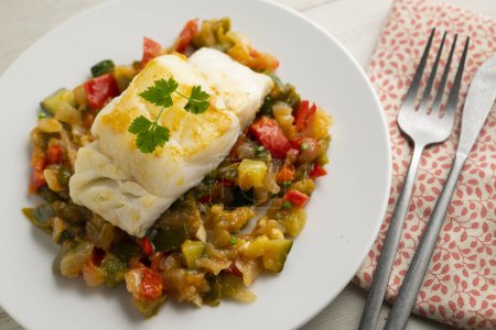 Photo for Cod tapa cooked with vegetables in samfaina. Traditional recipe of Spanish gastronomy. - Royalty Free Image