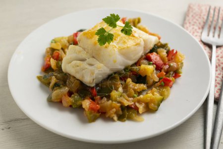 Photo for Cod tapa cooked with vegetables in samfaina. Traditional recipe of Spanish gastronomy. - Royalty Free Image