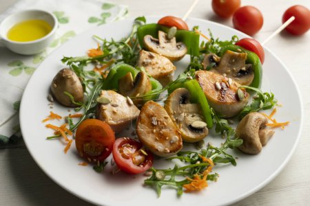 Téléchargez les photos : Brochettes de poulet bio aux champignons et salade. - en image libre de droit