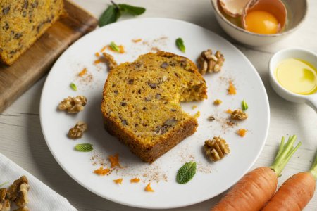 Photo for Delicious and fluffy carrot cake with walnuts on a wooden board. - Royalty Free Image