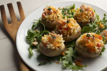 Photo for Mushrooms stuffed with rice salad with turkey and vegetables. - Royalty Free Image