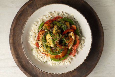 Photo for Chicken cooked in a wok with colorful peppers and rice. - Royalty Free Image